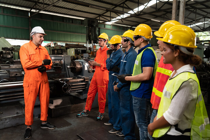 Skilled trades professor speaking to students in shop